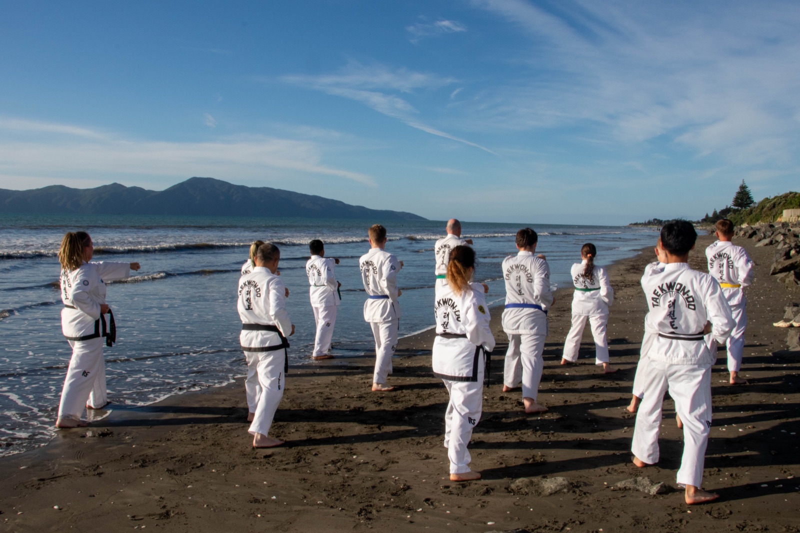 Kāpiti Coast TaeKwon-Do Club members of all ages training together on the beach